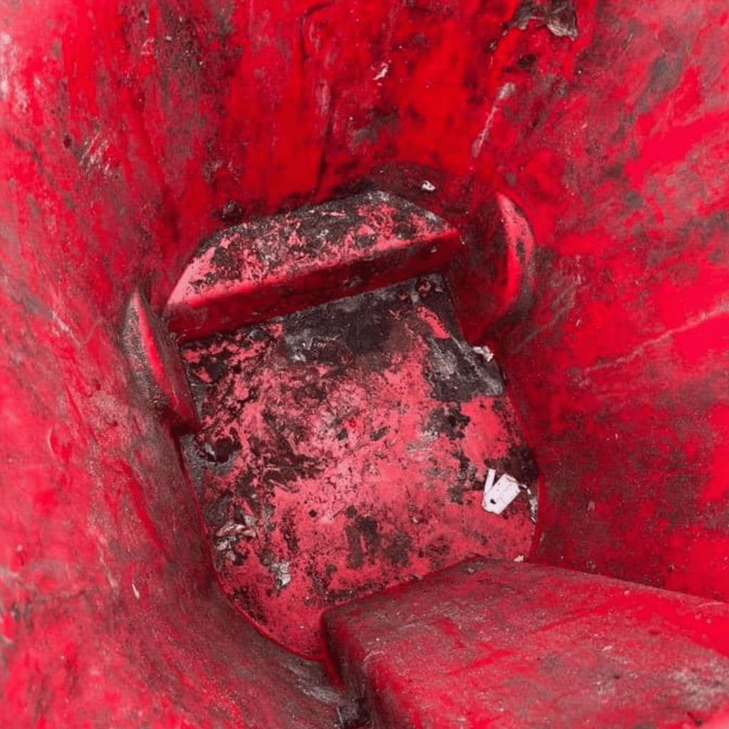 Before photo of dirty red trash bin interior